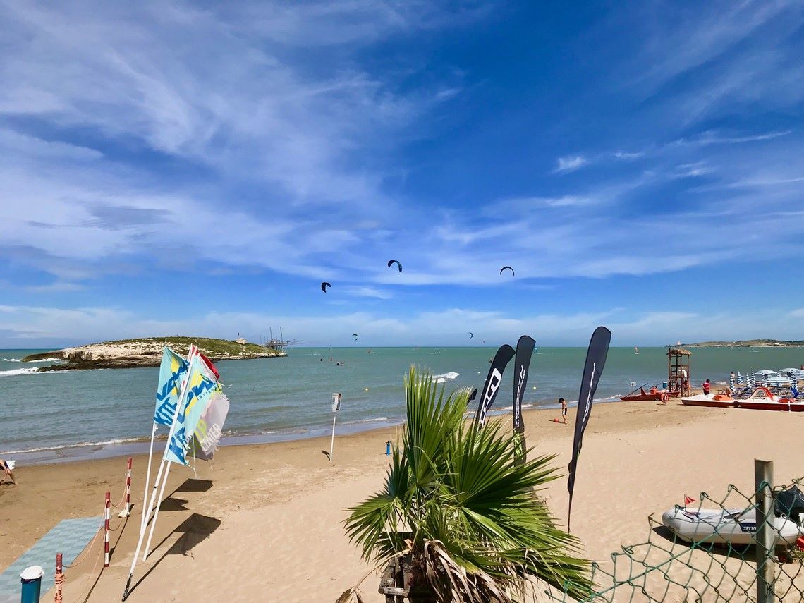 ragazzi e ragazze che fanno kitesurf e sport acquatici nell'Isola La Chianca Vieste